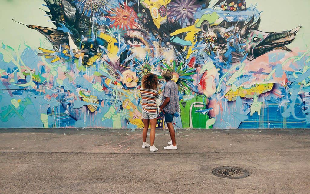 Couple enjoying street art at Wynwood Walls in Miami